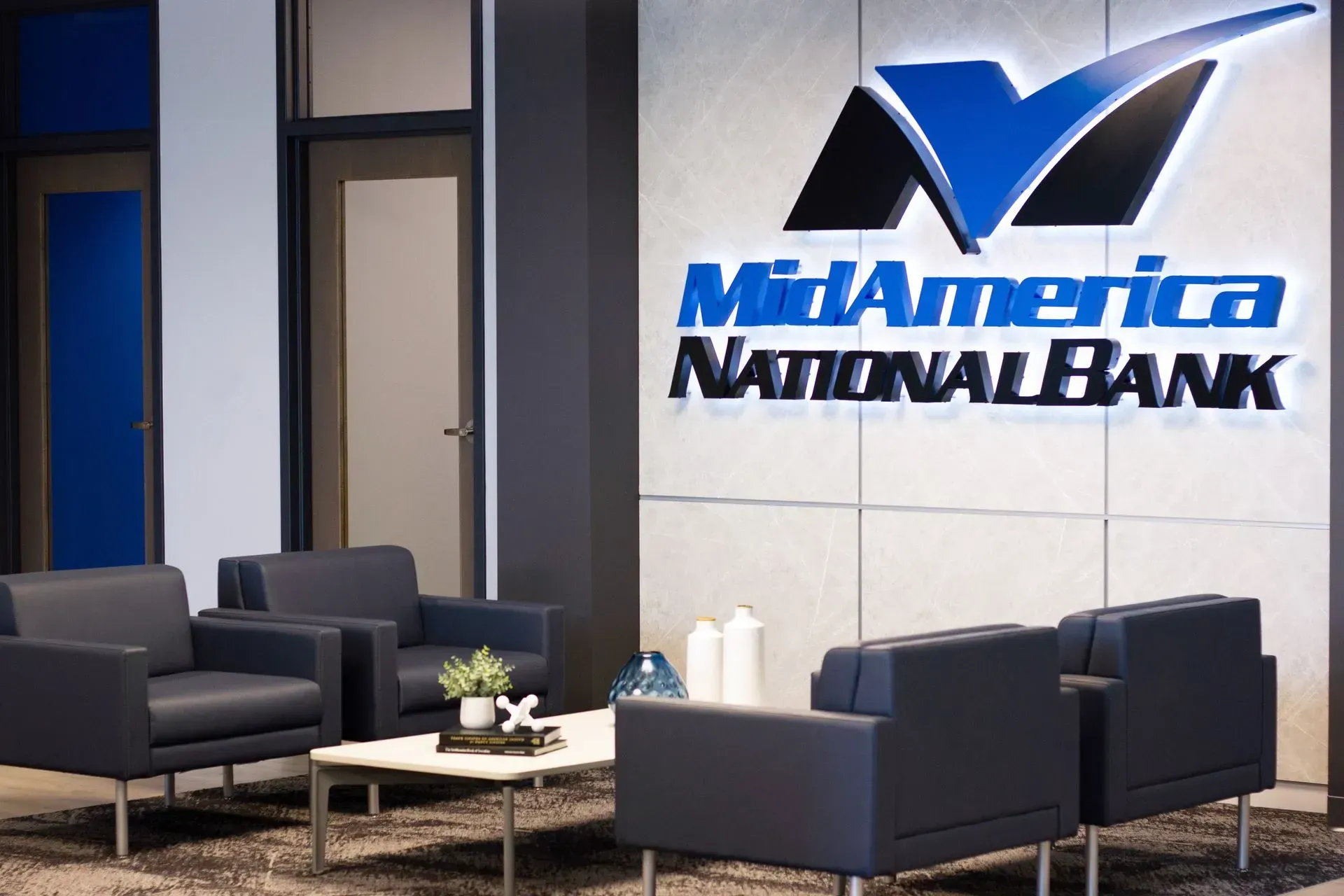 Lobby of MidAmerica National Bank with logo above seating area.