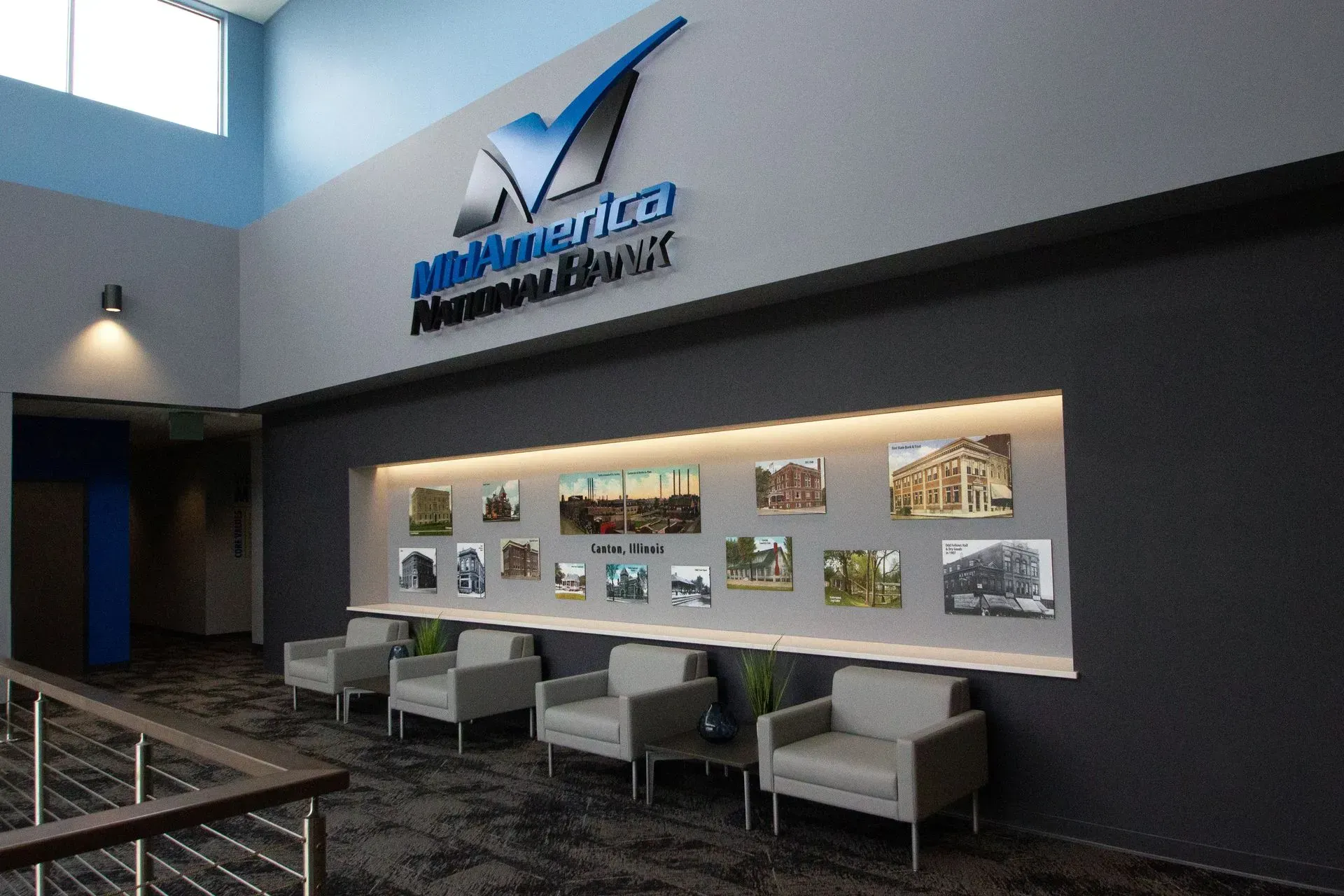 Interior lobby of MinnAmerica Federal Credit Union with seating and historical photos.