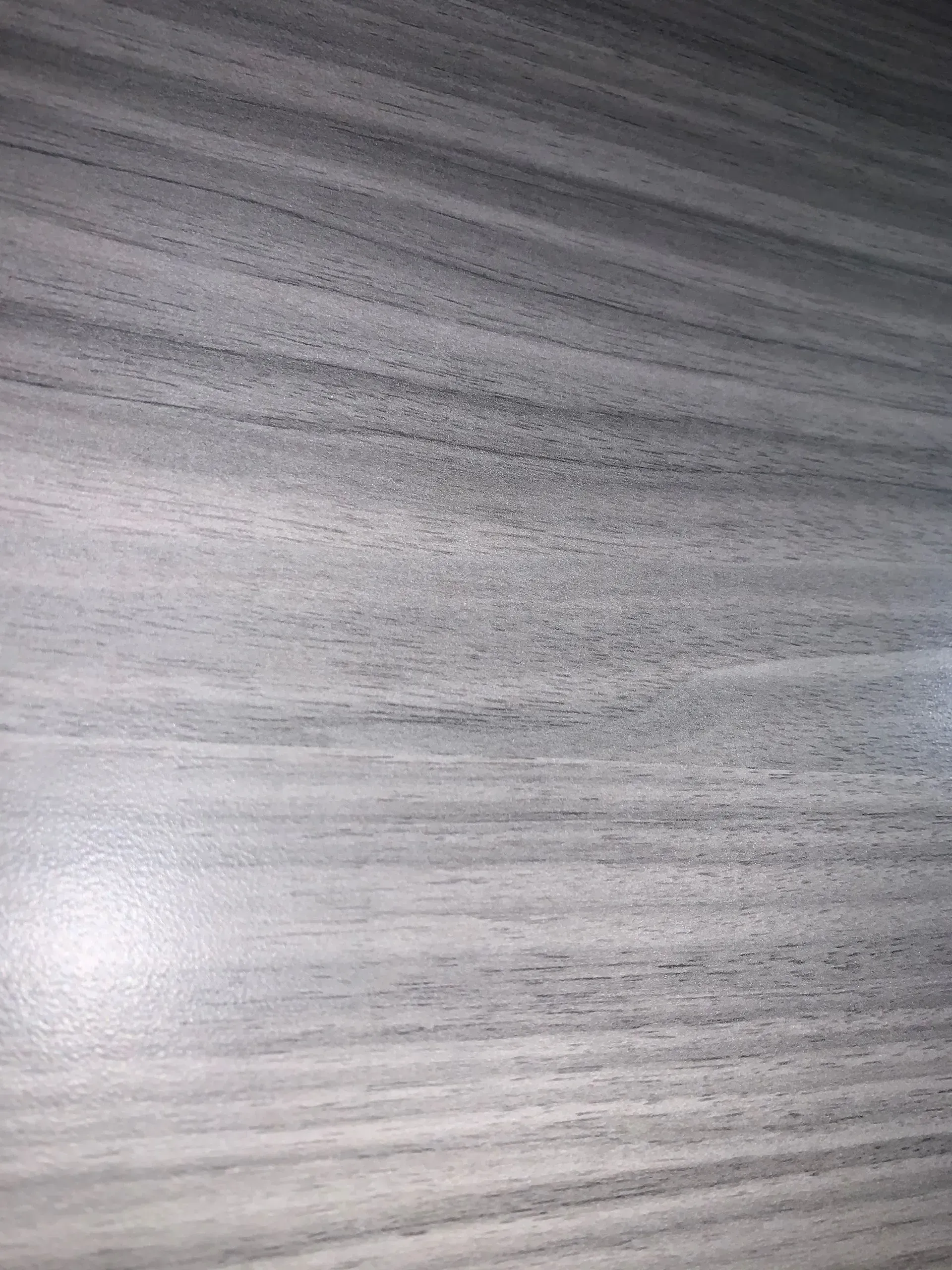 Wood grain texture in shades of gray.