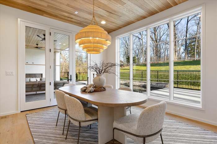 A dining room with a table and chairs and a chandelier.