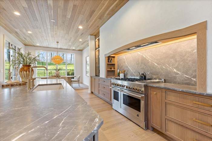 A kitchen with stainless steel appliances and wooden cabinets.