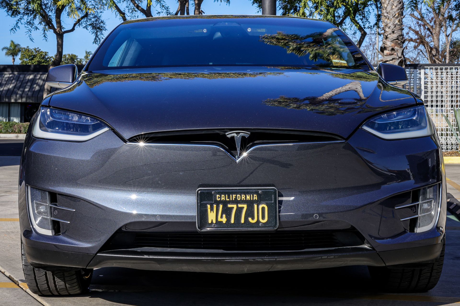 A black mercedes benz glc 300 is parked on a sidewalk.