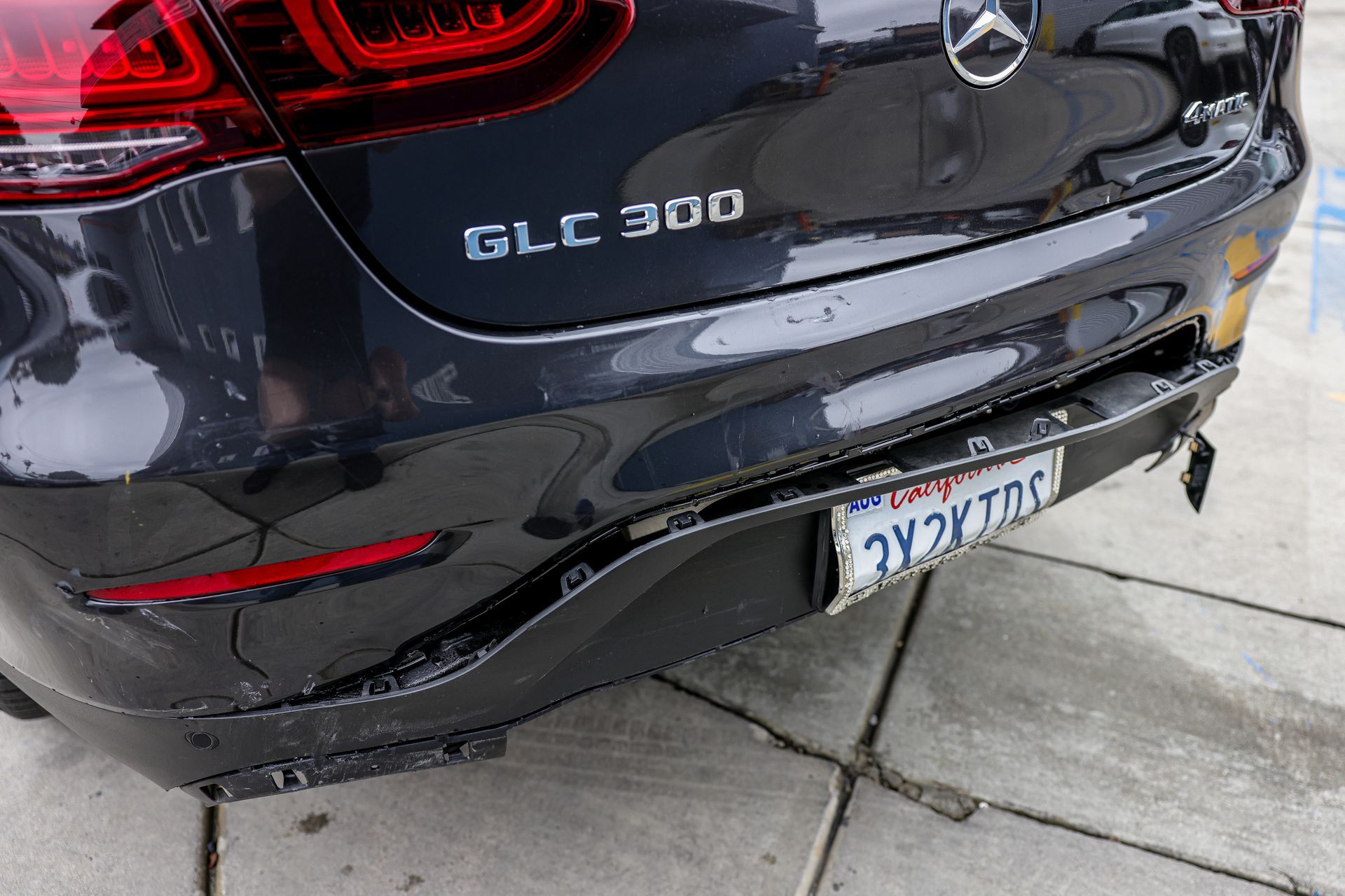 A tesla model x is parked in a parking lot with a california license plate