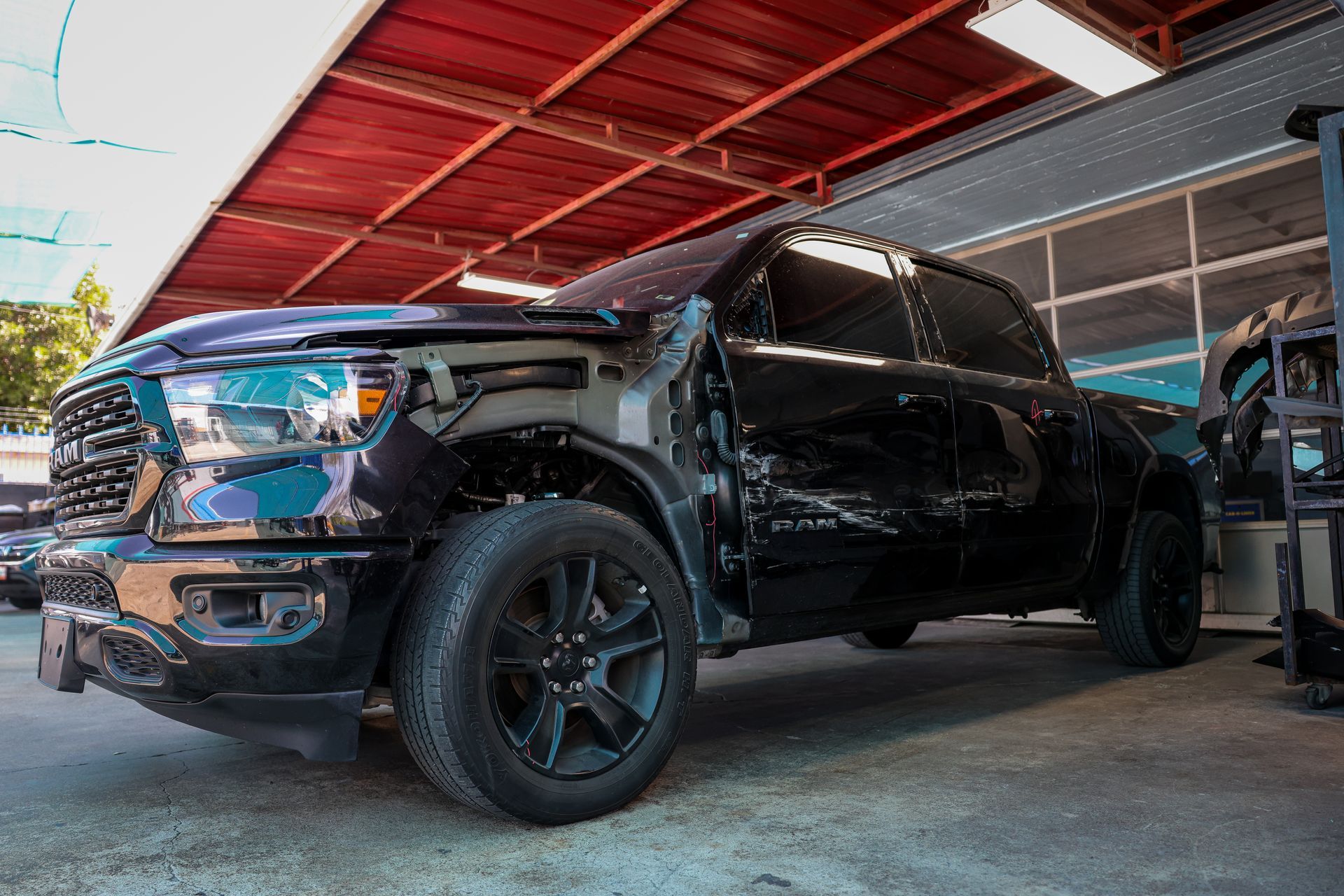 A man is working on a car in a garage.