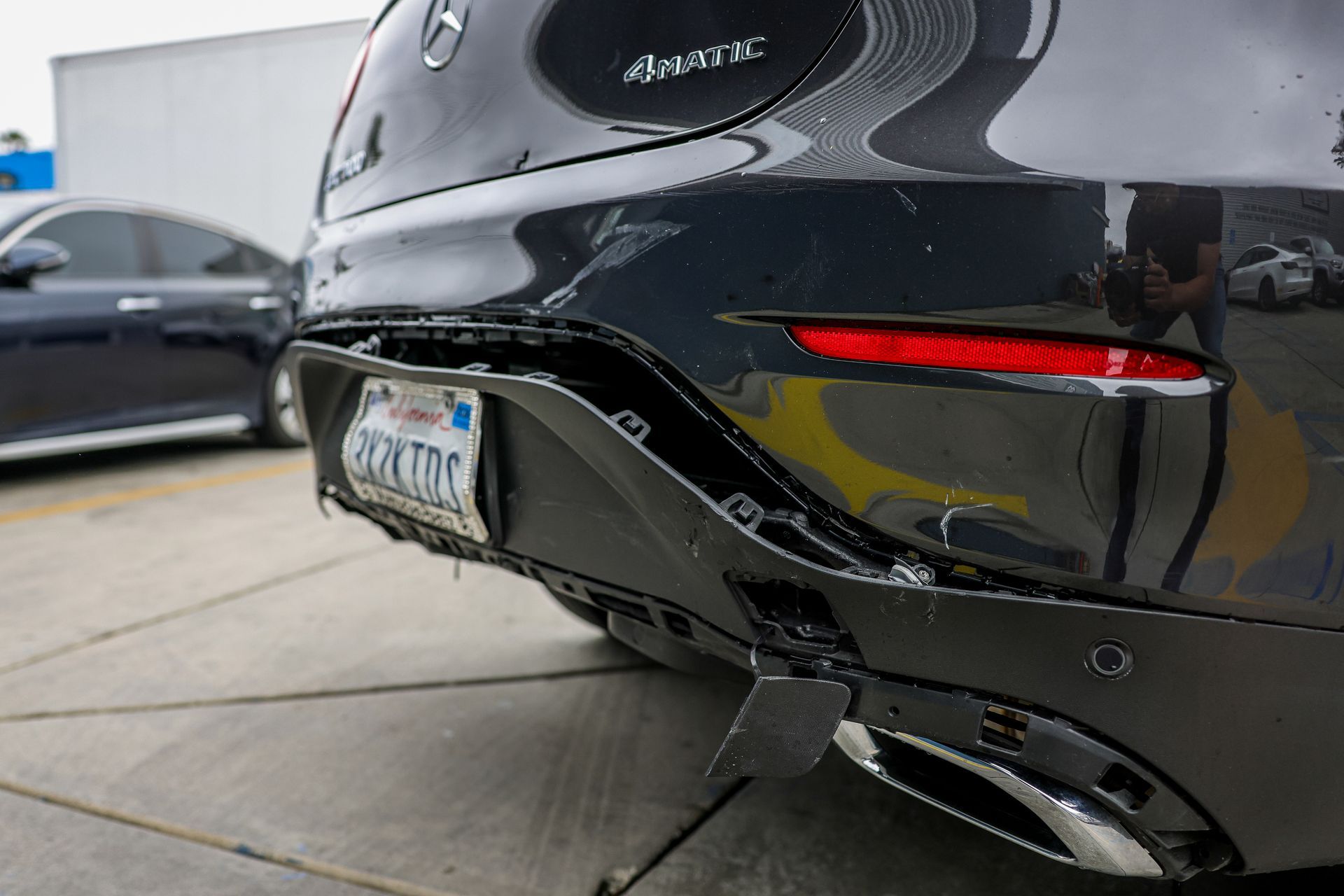 A silver tesla model s is parked in a parking lot