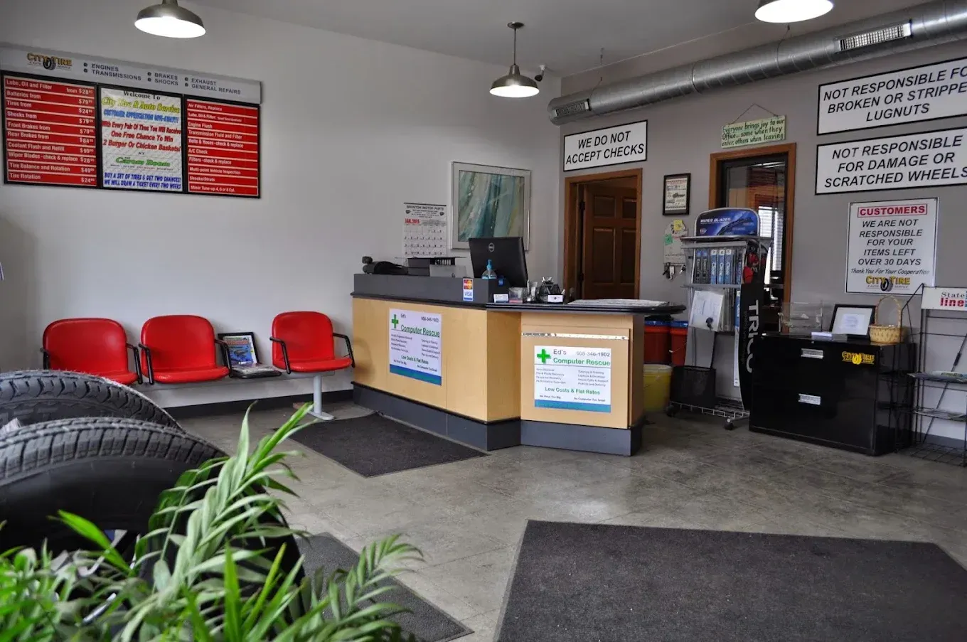 Small lobby with red chairs, reception desk, coffee station, and menu boards on the wall.
