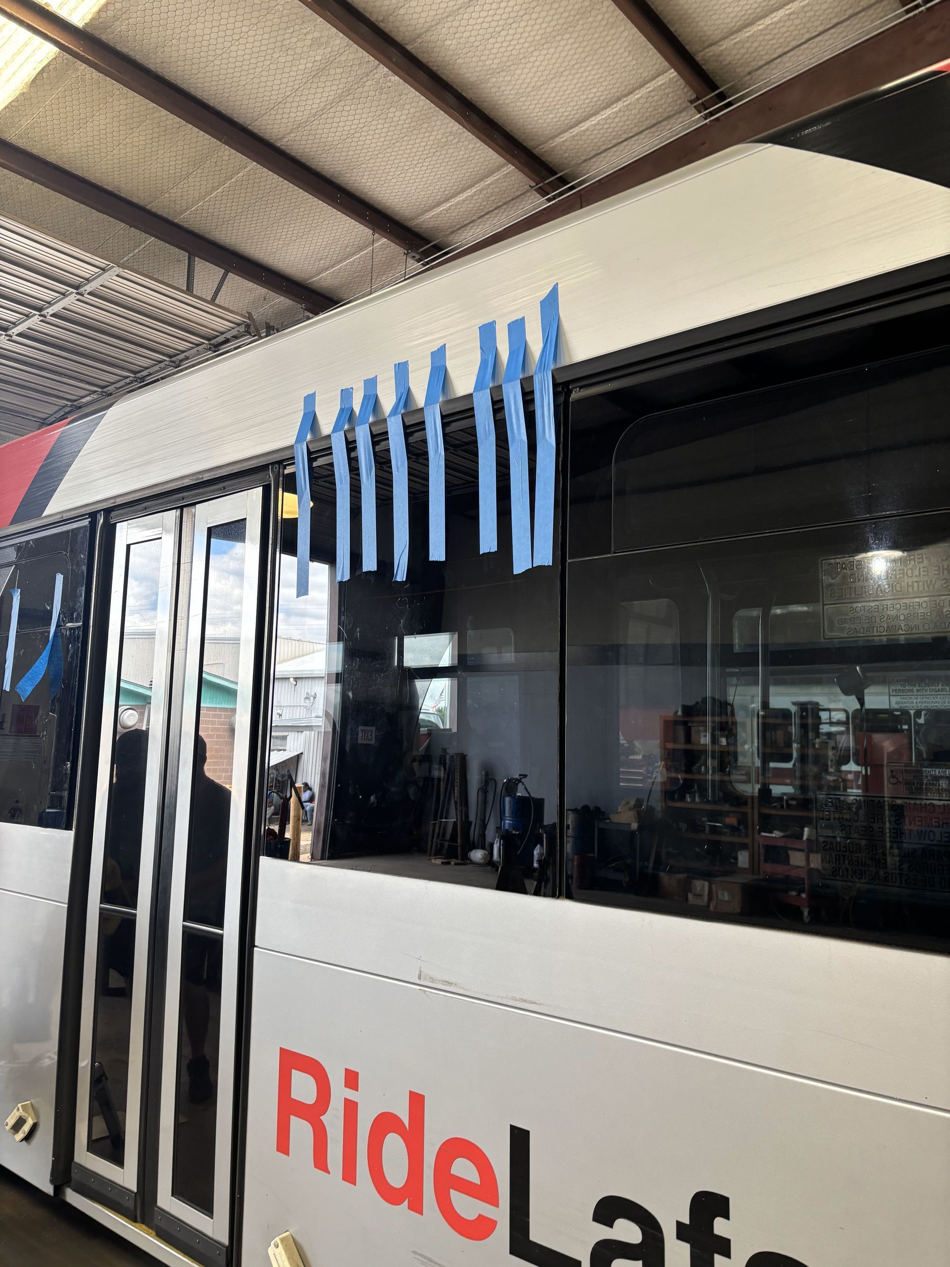 A bus is parked in a garage with the word ride on it.