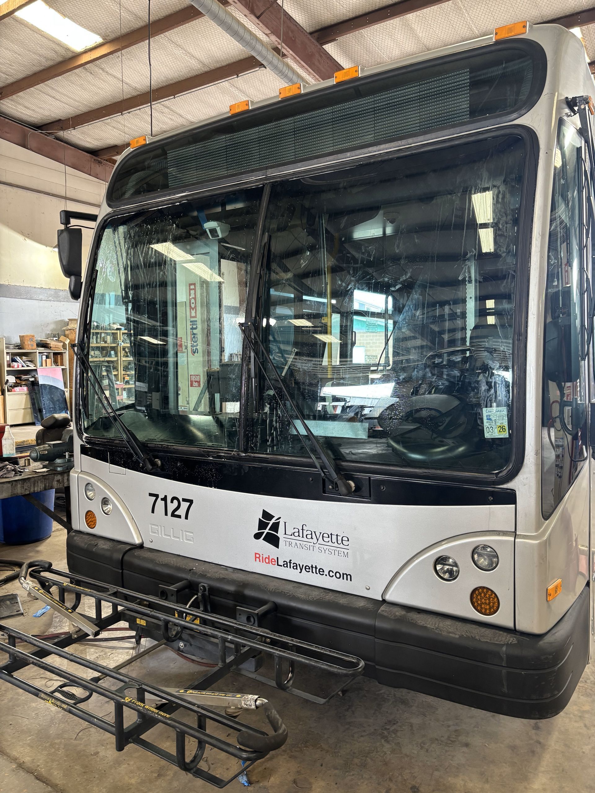 A bus is being repaired in a garage.