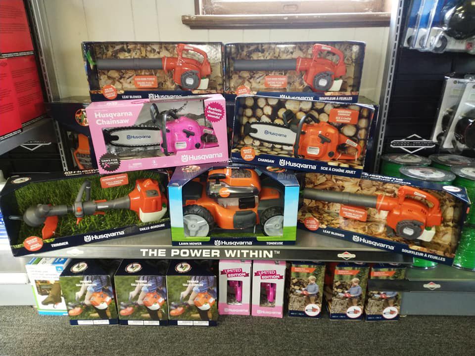 A display of husqvarna lawn mower toys on a shelf
