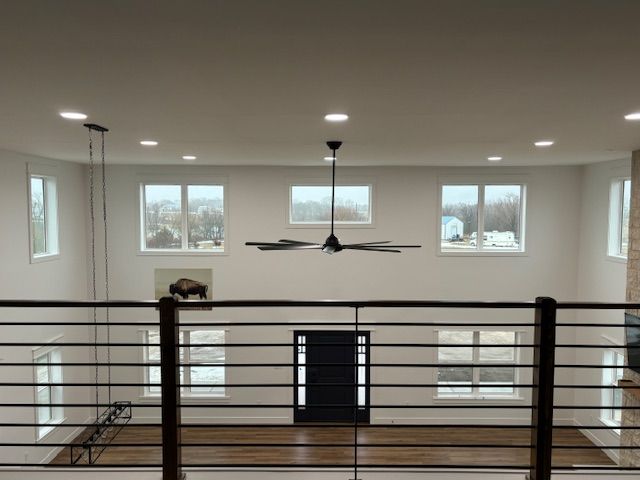 a large room with a ceiling fan and a black door