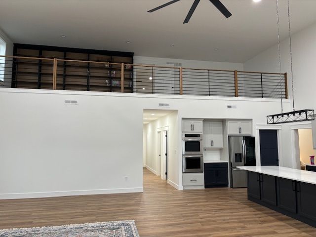 a kitchen with a ceiling fan and a balcony