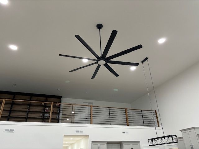 a ceiling fan is hanging from the ceiling of a room