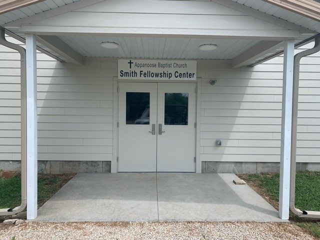 a white building with a sign that says smith fellowship center
