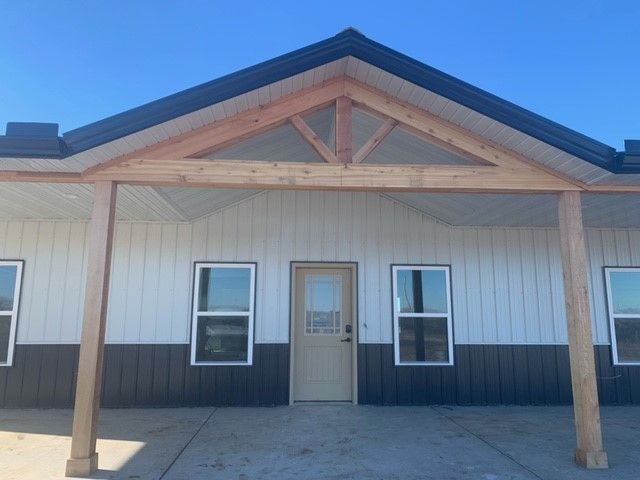 a white and black house with a wooden porch
