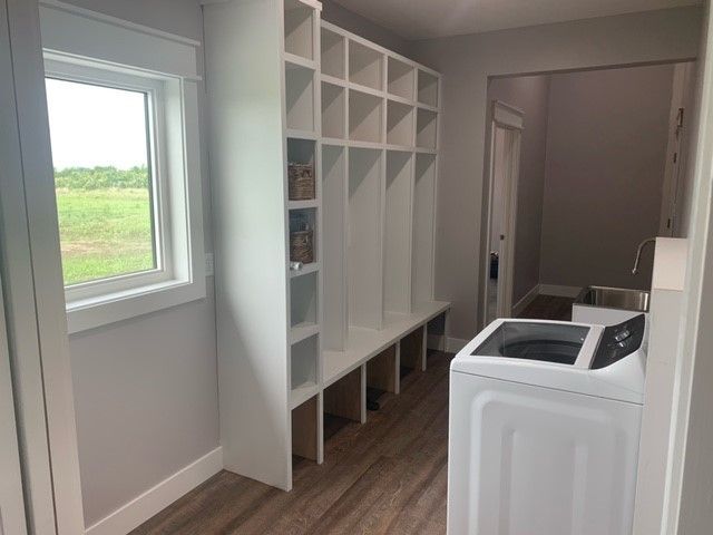 a laundry room with a washer and dryer and a window