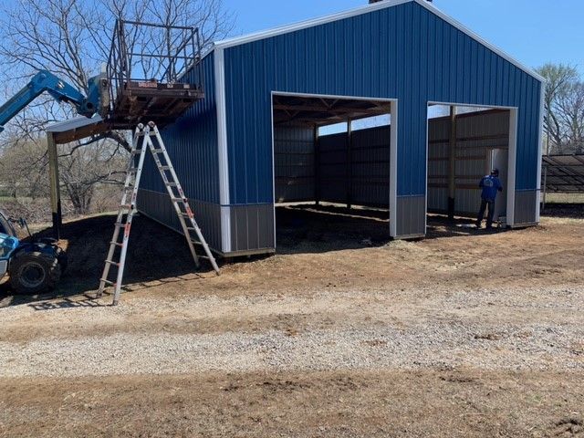 a man is standing inside the blue building