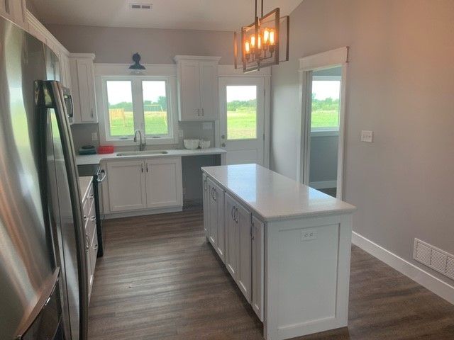 a kitchen with a large island in the middle of it