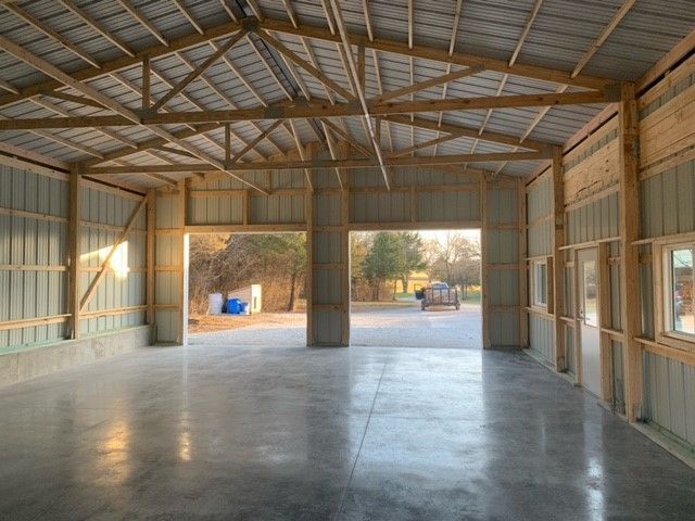 a large empty building with a garage door open