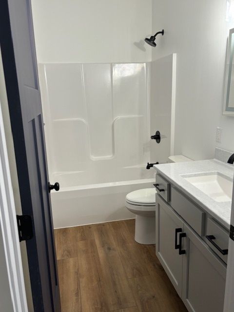 a bathroom with a toilet, sink, and bathtub