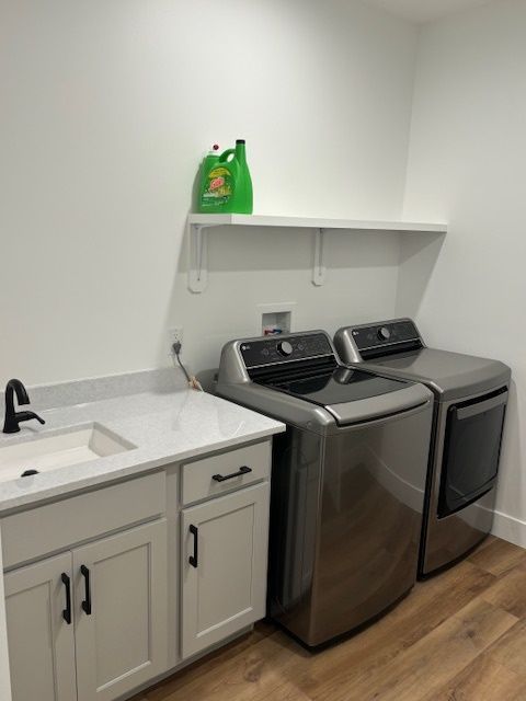 a laundry room with washer, dryer and sink