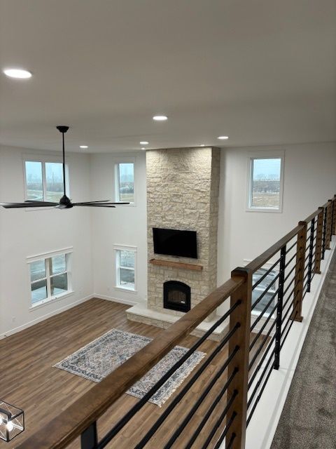 a living room with a fireplace and a ceiling fan