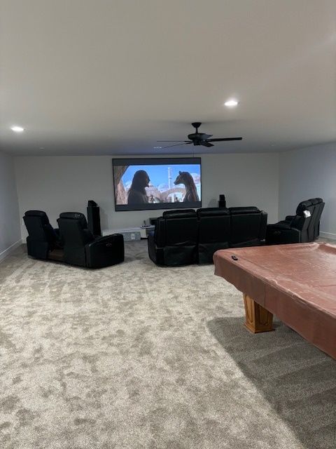 movie room setting with a television turned on