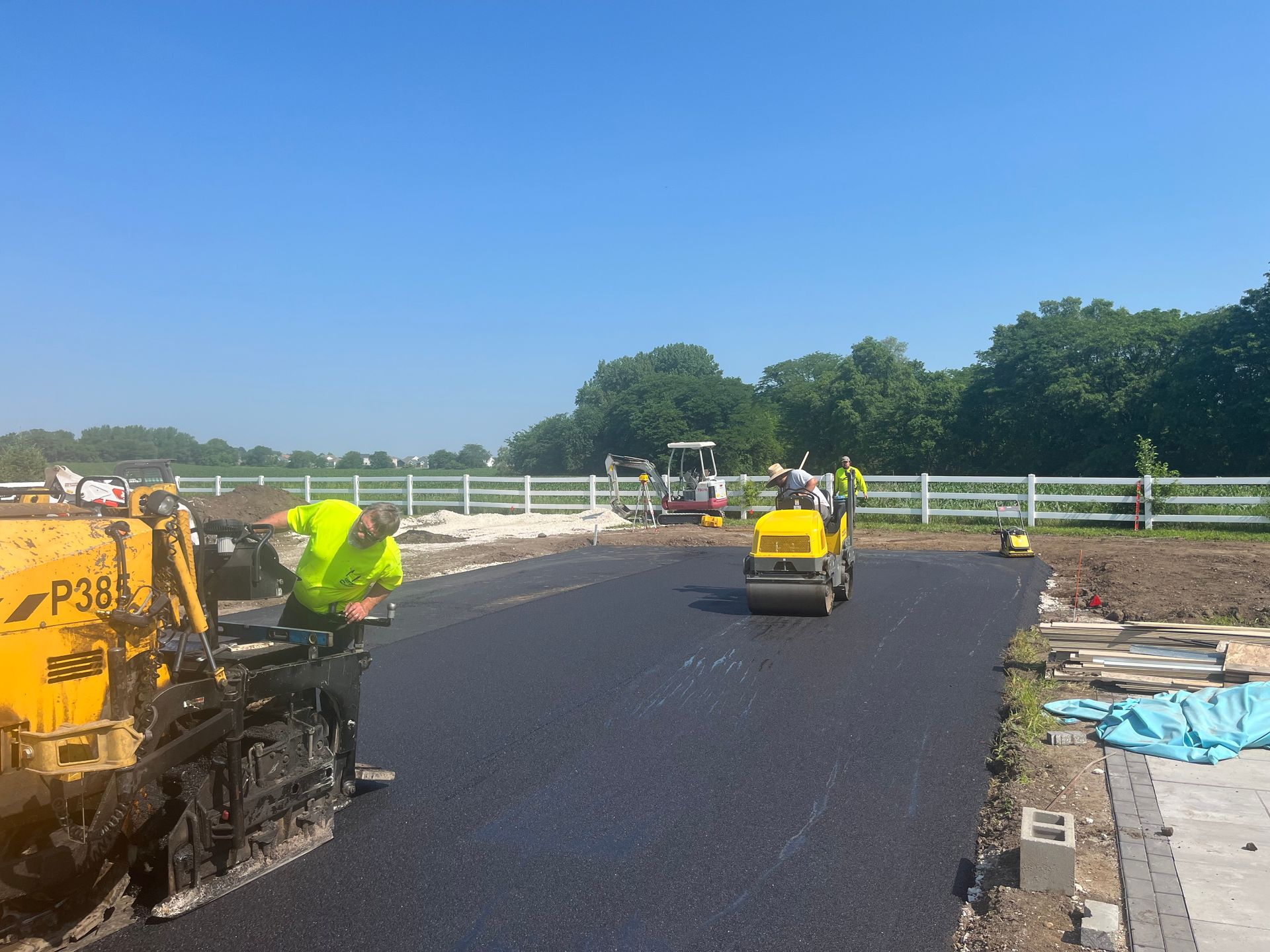 A group of construction workers are working on a road.