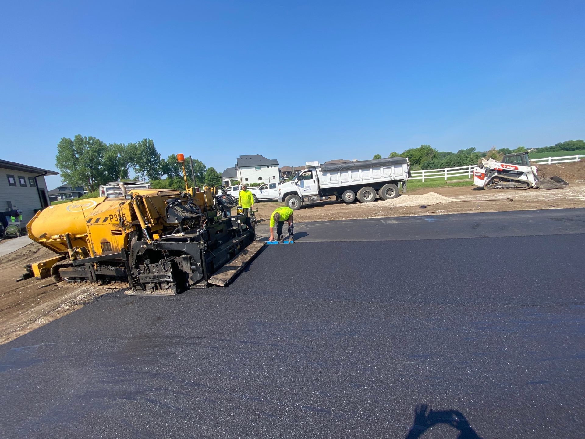 A group of construction workers are working on a road.