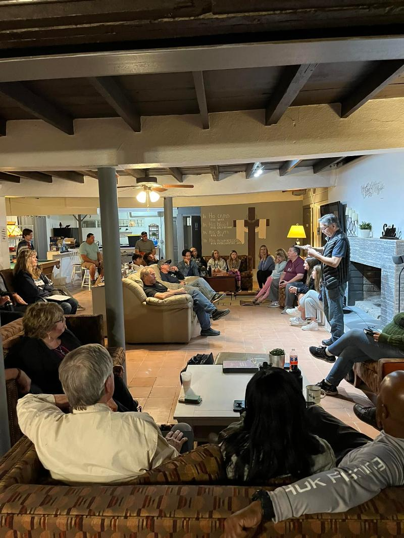 A group of people are sitting in a living room.