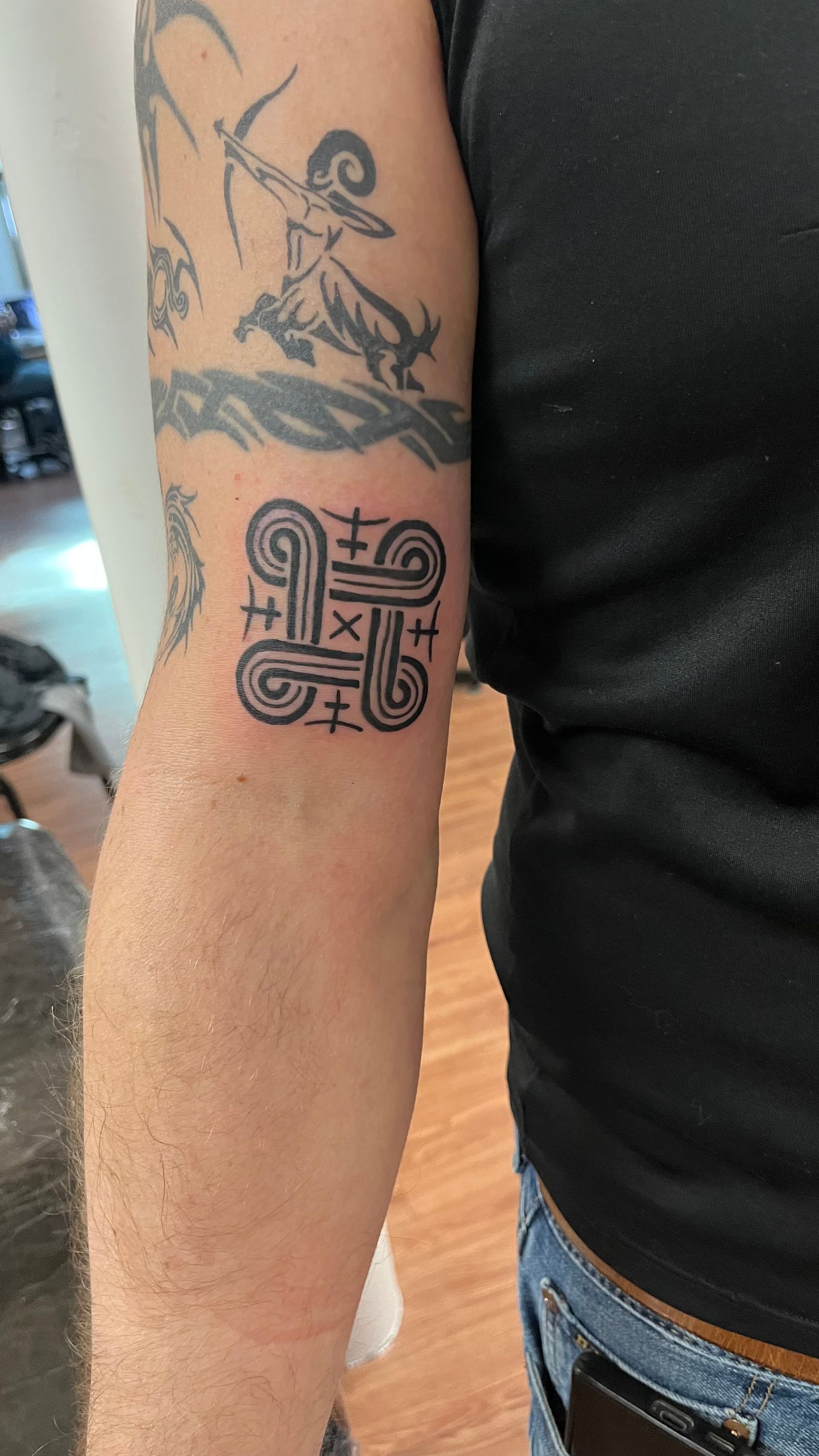 A close up of a person 's arm with a tattoo on it.