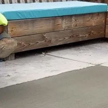 concrete repair next to a wooden bench with a blue cushion