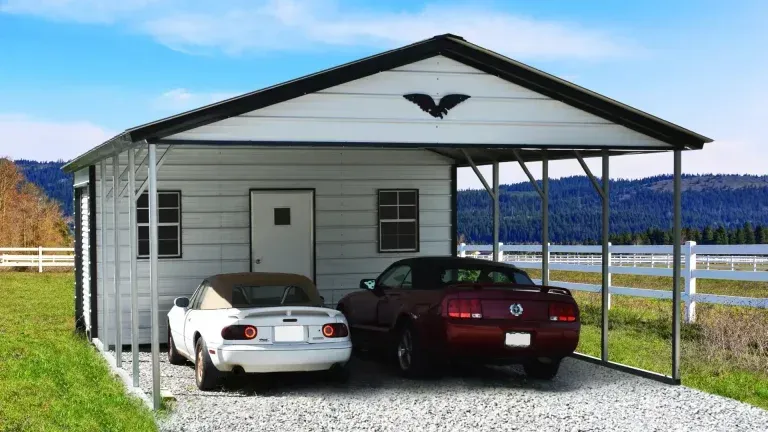 Two cars are parked under a carport with an eagle on the roof.