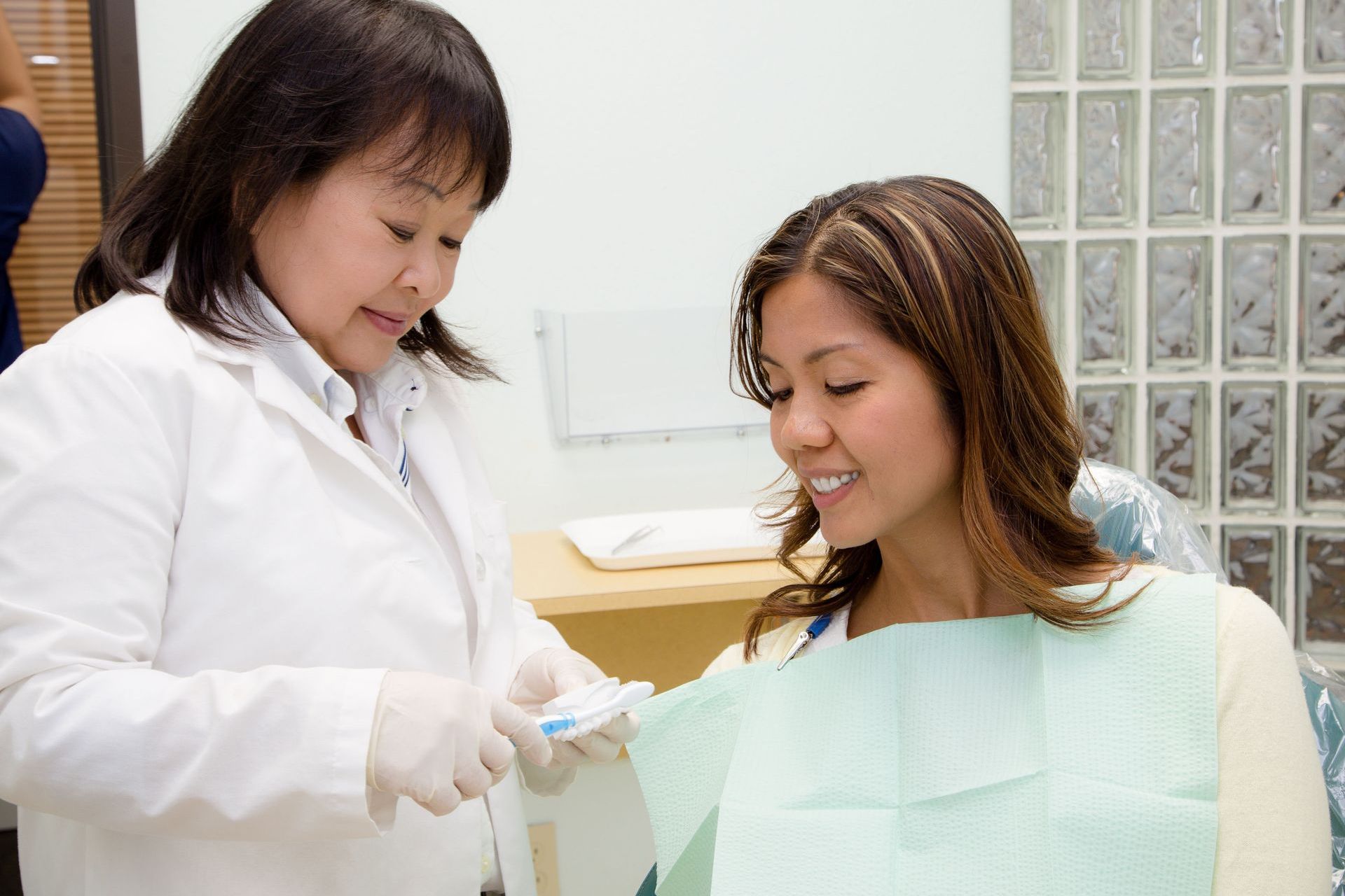 Dentist in white coat and a patient