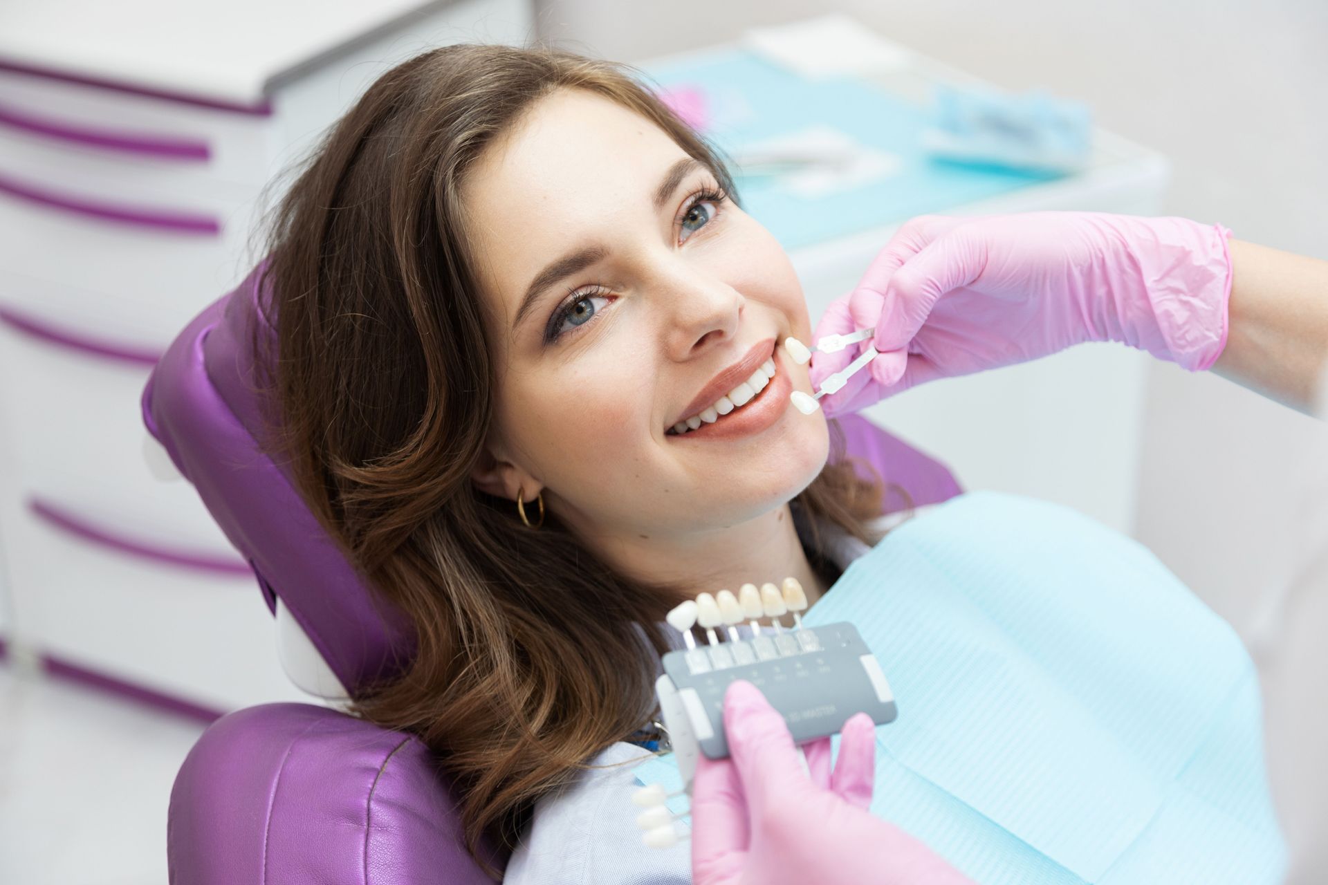 Smiling patient reclining in a dental chair