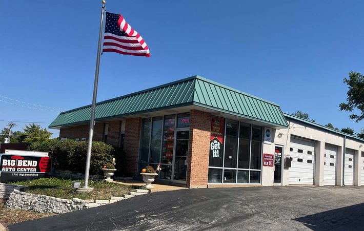 An american flag is flying in front of a building.