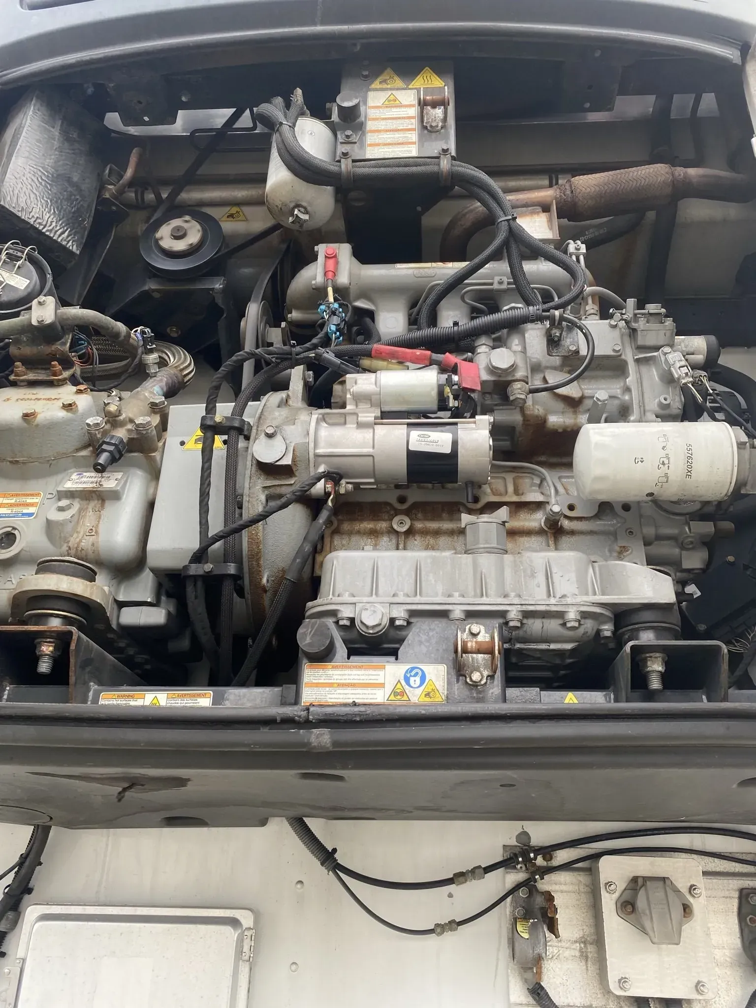 Diesel engine in a refrigerated trailer; various components visible including belts, wiring, and filters.