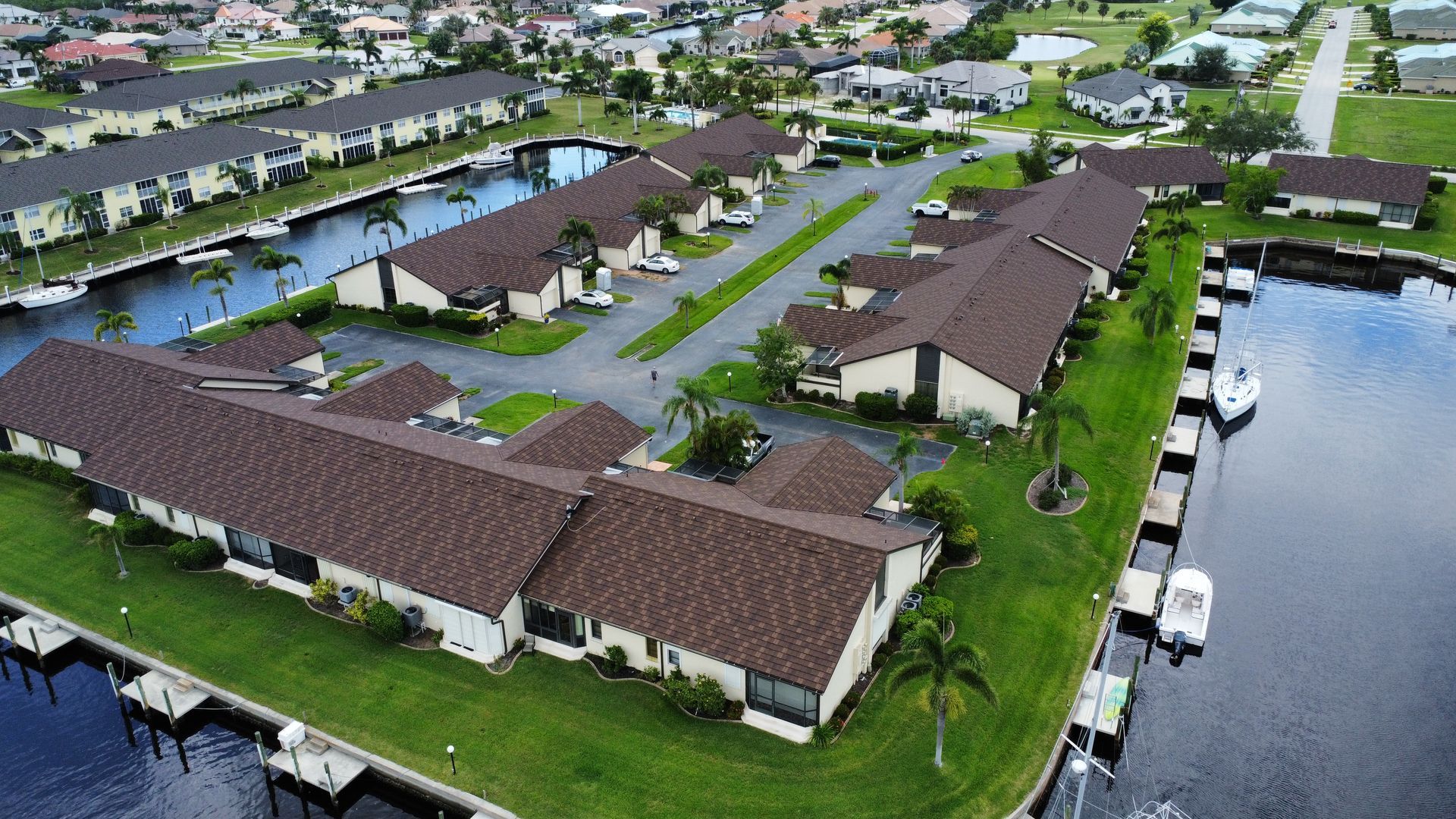 An aerial view of a residential area next to a body of water