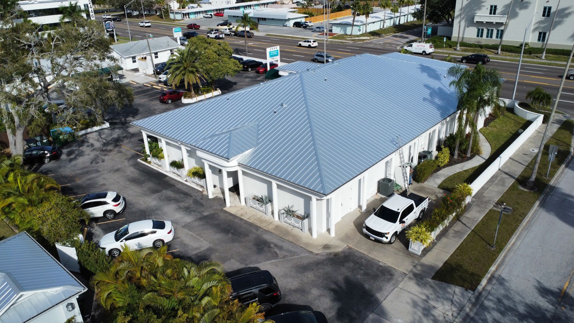 An aerial view of a building with cars parked in front of it.