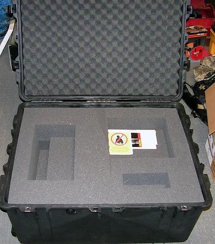 A black foam case with a warning label on it