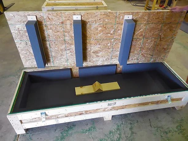 A wooden box with a black tray inside of it.