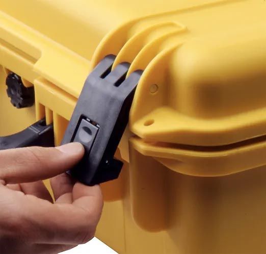 A person is opening a yellow plastic case with their finger