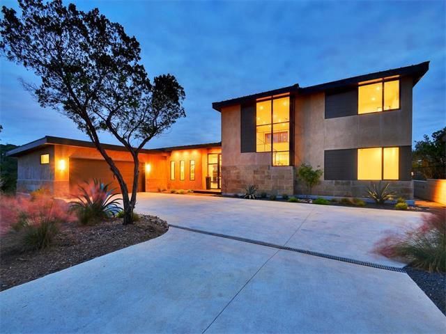 A house with a lot of windows and a tree in front of it.