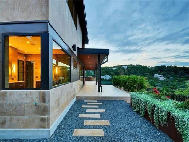 A large house with a walkway leading to it.