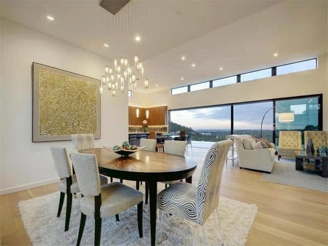 A dining room with a table and chairs in it.