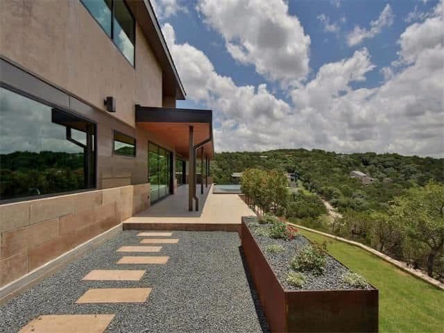 A house on a hill with a walkway leading to it.