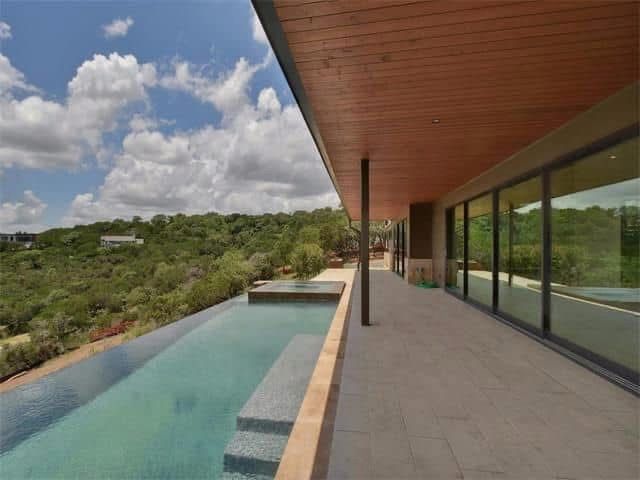 A large house with a swimming pool on the side of it.