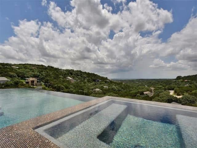 A large swimming pool with stairs leading to it.