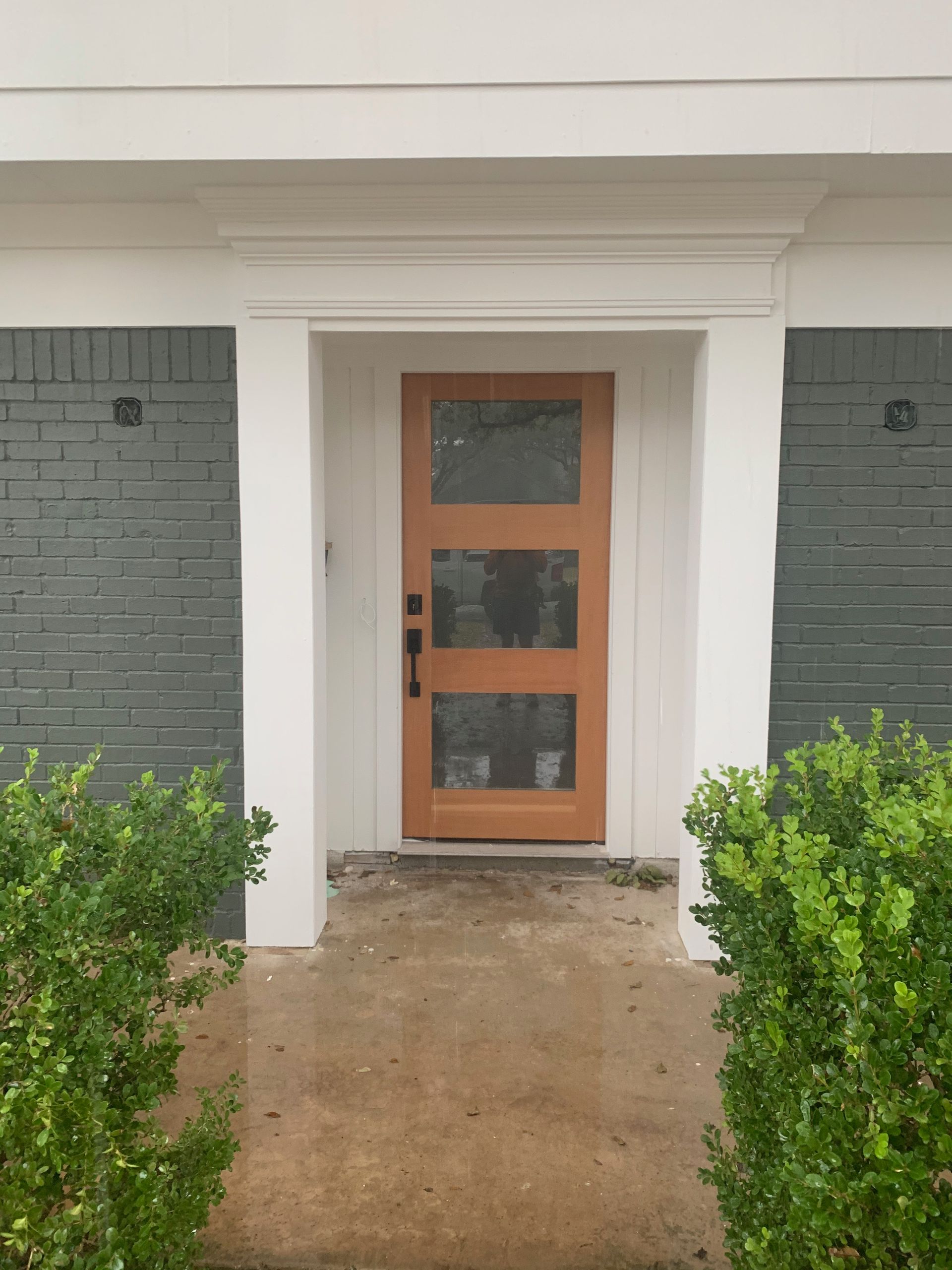The front door of a house with a wooden door.