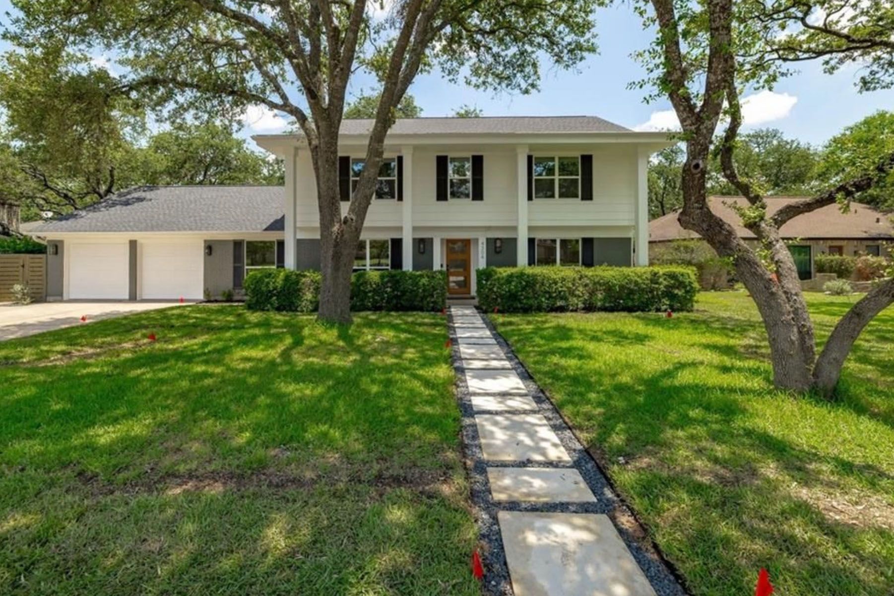 The front of a house with a walkway leading to it.