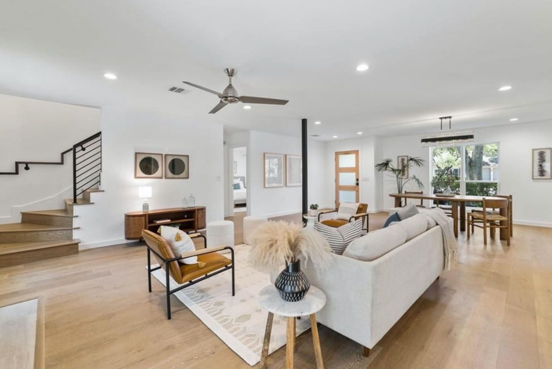 A living room filled with furniture and a ceiling fan.
